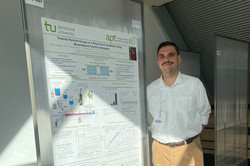 Max Kattner standing beside his poster