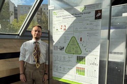 Lukas Seppelfricke standing beside his poster