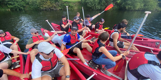 Group Photo of 5 Canoes on a river with several people